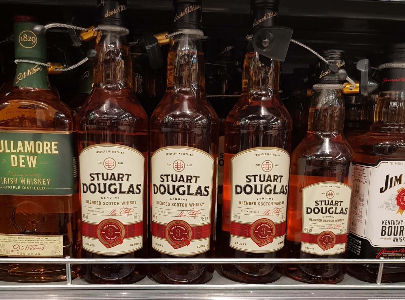 Stuart Douglas 0.7 and 0.5 litre bottles on a shop shelf
